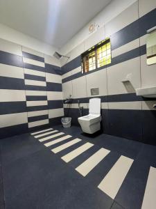 a bathroom with a toilet and a sink at Mount court munnar in Munnar
