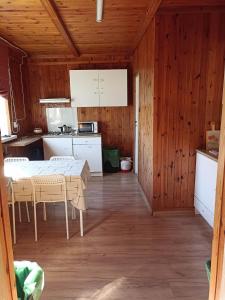 a kitchen with a table and chairs in a room at Green House in Wola Przypkowska