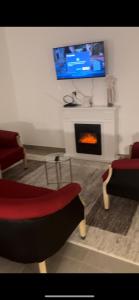 a living room with a fireplace and a tv at Antemurale - Luxury rooms,Plitvice Lakes in Rastovača
