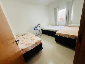 a room with two beds and a window at Casa para temporada Caldas Novas-GO Brasil in Caldas Novas +17 photos