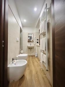 a white bathroom with a sink and a toilet at La Villetta Food & Drink Rooms for Rent - No Reception - in LʼAquila