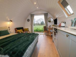 a bedroom in a tiny house with a large bed at Oh Deer in Ashbourne