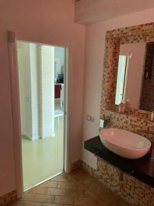 a bathroom with a sink and a mirror at Agriturismo I Tassoni in Pavullo nel Frignano