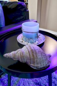 a table with a cup and a plate on it at Aqueous - A Birdy Vacation Rental in San Antonio