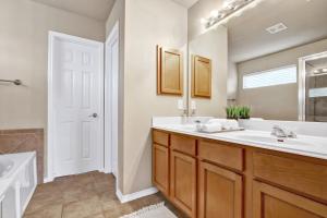 a bathroom with a sink and a mirror at Aqueous - A Birdy Vacation Rental in San Antonio
