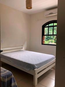 Casa em Ubatuba - Perequê-Mirim tesisinde bir odada yatak veya yataklar