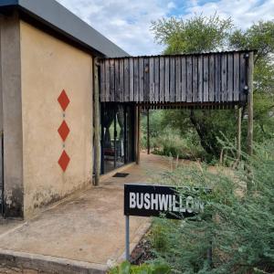 a sign in front of a building with a house at Hackberry House Bushwillow Cottage (Off Grid) in Khemsbok