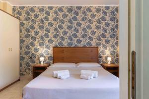 Ліжко або ліжка в номері Hotel Riva Etrusca