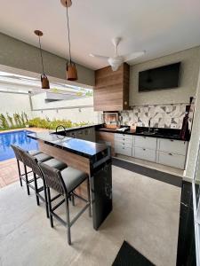 a kitchen with a table and chairs and a pool at NoMar in Guarujá