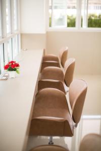 a row of chairs in a waiting room with flowers at P.A. Thani Hotel in Nakhon Sawan