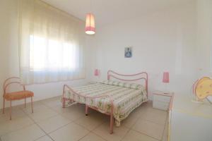 Giường trong phòng chung tại Rif. B12 - DELFINO 2