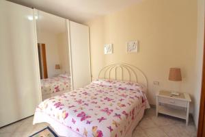 a small bedroom with a bed and a mirror at Rif. B16 - MEDITERRANEO in San Vincenzo