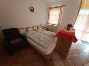 1 dormitorio con 2 camas individuales y 1 silla en Apartma Brešan, en Kobarid