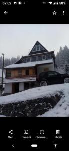 a house with a car parked in the snow at Kopaniktreskapotok15eu in Kopaonik