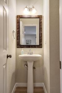 a bathroom with a sink and a mirror at Bluebonnet - A Birdy Vacation Rental in San Antonio +42 photos