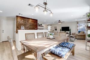 a dining room and living room with a wooden table and chairs at Bluebonnet - A Birdy Vacation Rental in San Antonio