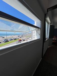 a window in a room with a view of a race track at La PerlaApart in Mar del Plata
