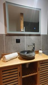 a bathroom counter with a sink and a mirror at Chalet Le Dahu in La Bresse