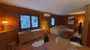 a living room with a couch and a table at Chalet Le Dahu in La Bresse