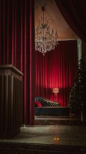 a room with a red curtain and a chandelier at Dervish Han Boutique Hotel in Istanbul