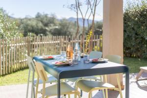 a blue table with chairs and drinks on it at Residence Piatana in Olmeto