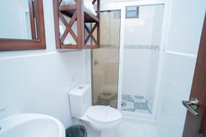 a bathroom with a toilet and a glass shower at Villa Shalom in Santa Rosa de Copán