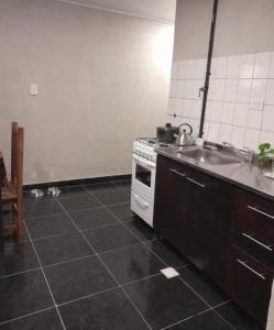 a kitchen with a sink and a stove at Carileufu in Comandante Luis Piedra Buena +2 photos