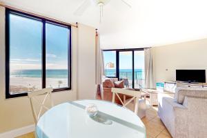 a living room with a view of the ocean at Sunbird #408E in Panama City Beach
