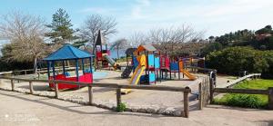 een speeltuin met kleurrijke speeltoestellen in een park bij Appartement cap esterel vue mer in Saint-Raphaël