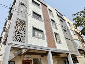 a building with a facade with a lot of windows at Hotel Subham Beach inn ! PURI near-sea-beach-and-temple fully-air-conditioned-hotel with-lift-and-parking-facility in Puri
