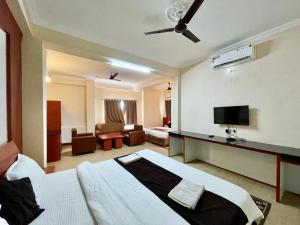 Hotel Subham Beach inn ! PURI near-sea-beach-and-temple fully-air-conditioned-hotel with-lift-and-parking-facility في بوري: فندق غرفه بسرير وصاله