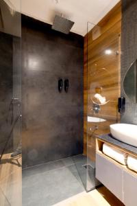 a bathroom with a glass shower and a sink at Aceotel Select Tulsi Vijay Nagar- A Luxury Boutique Hotel in Indore