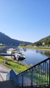 a river with boats docked on the side of it at Lilienstein in Königstein an der Elbe
