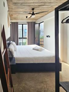 a bedroom with a bed and a ceiling fan at Aldea Paraíso - Adults only - Boutique hotel in Puerto Escondido