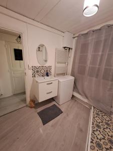 La salle de bains est pourvue d'un lavabo et d'un miroir. dans l'établissement A Mammulejiu, à Thiers