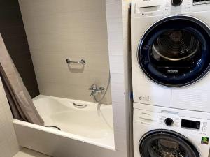 a washing machine and a washer in a bathroom at Luxury 4BR with 3 Bathrooms Apartment in Marousi in Athens