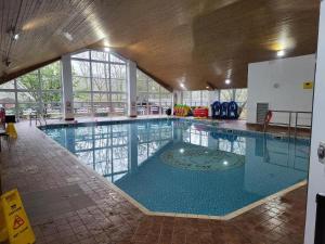a large swimming pool in a building at White Cross Bay Deer View in Windermere