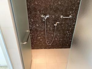 a shower stall in a bathroom with a black and white wallpaper at Luxury 4BR with 3 Bathrooms Apartment in Marousi in Athens