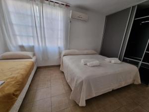 Una cama o camas en una habitación de ParSur alquileres temporales Catamarca
