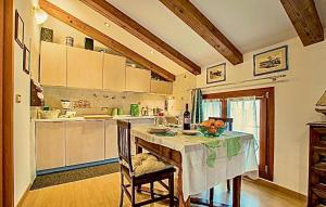 a kitchen with a table with a bowl of fruit on it at CA' LEONE - Sans Souci - Apartment with Pool in Mira