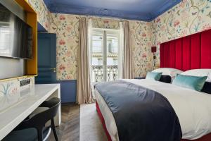 a bedroom with a large bed and a red headboard at Séjours Parisiens - Suites Haussmann, Malesherbes & Madeleine in Paris