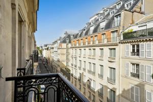 a view of a city street from a balcony at Séjours Parisiens - Suites Haussmann, Malesherbes & Madeleine in Paris