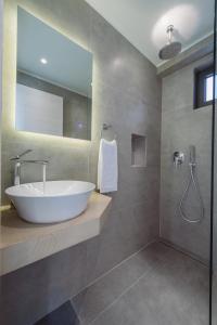 a bathroom with a large white sink and a shower at Luxury Villa Mon I Vassilikos in Vasilikos