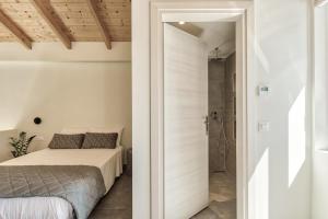 a bedroom with a bed and a walk in shower at Luxury Villa Mon II Vassilikos in Vasilikos