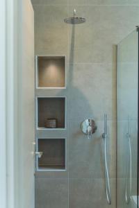 uma casa de banho com um chuveiro e uma porta de vidro em Luxury Villa Mon II Vassilikos em Vasilikos