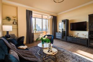a living room with a couch and a tv at hotelise l Riverview Apartment in Yerevan