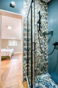 a shower in a room with a glass door and a bedroom at Miro guesthouse in Tivat +109 photos