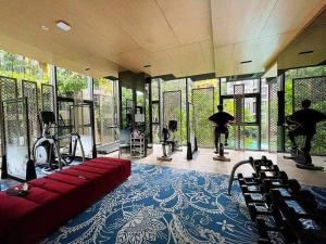 a room with a gym with people exercising in it at Phuket Town - Central Luxury in Phuket Town