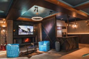 a living room with a tv and a fireplace at Residence Gudauri Hills in Gudauri