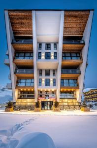 a building with snow in front of it at Residence Gudauri Hills in Gudauri